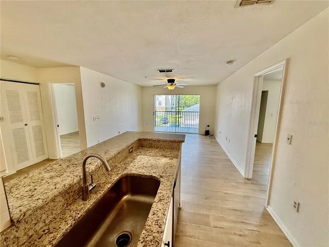 a view of a livingroom with wooden floor and entryway