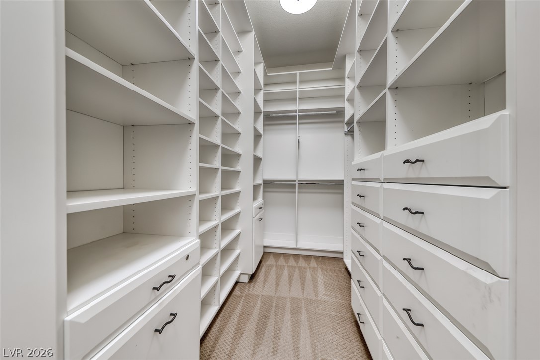 2122 Mooreview Street Henderson, NV 89012 - Photo 22 of 44 Ample storage solutions abound in this meticulously organized walk-in closet, maximizing space and utility.