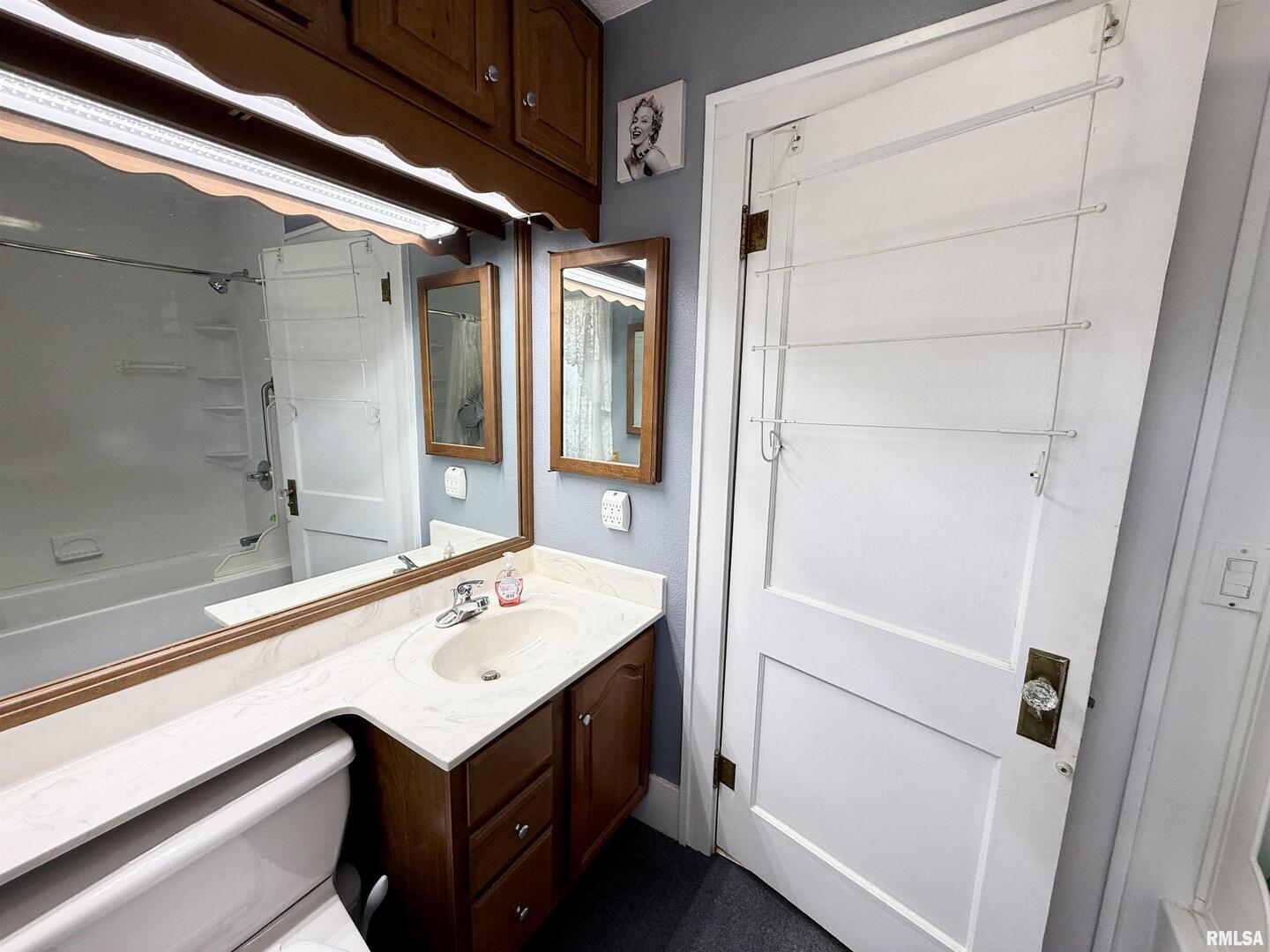 2340 7th Street East Moline, IL 61244 - Photo 11 of 26 a bathroom with a sink and mirror