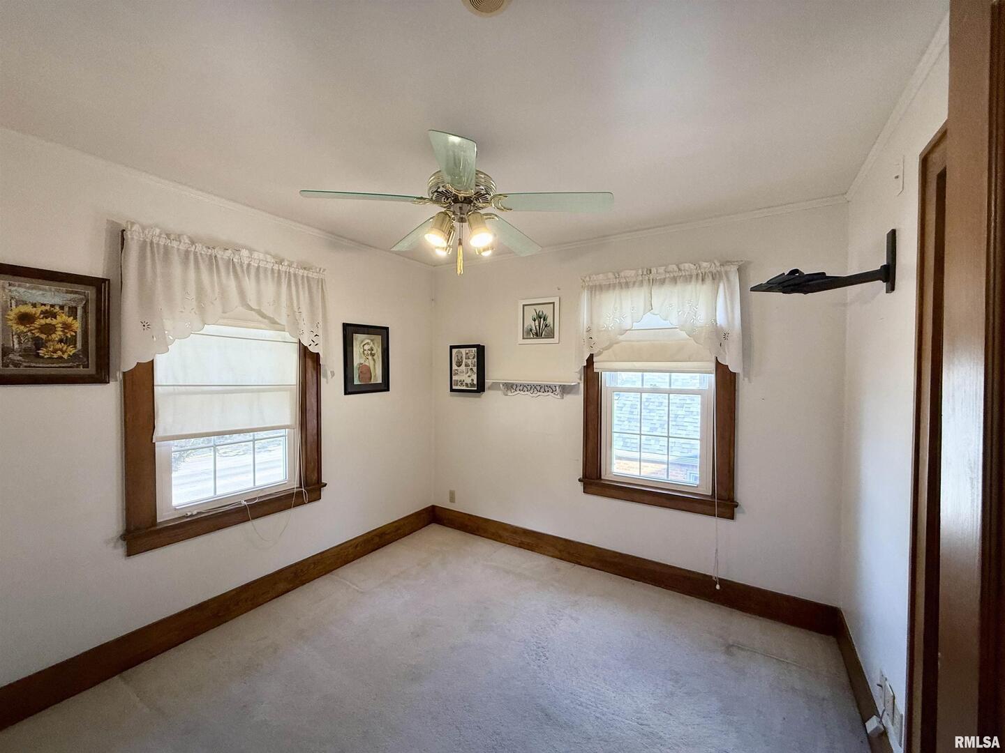 2340 7th Street East Moline, IL 61244 - Photo 17 of 26 an empty room with windows and fan