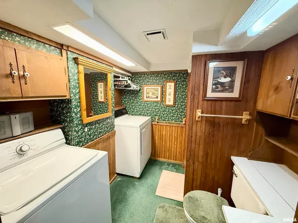 a living room with furniture a flat screen tv and a toilet