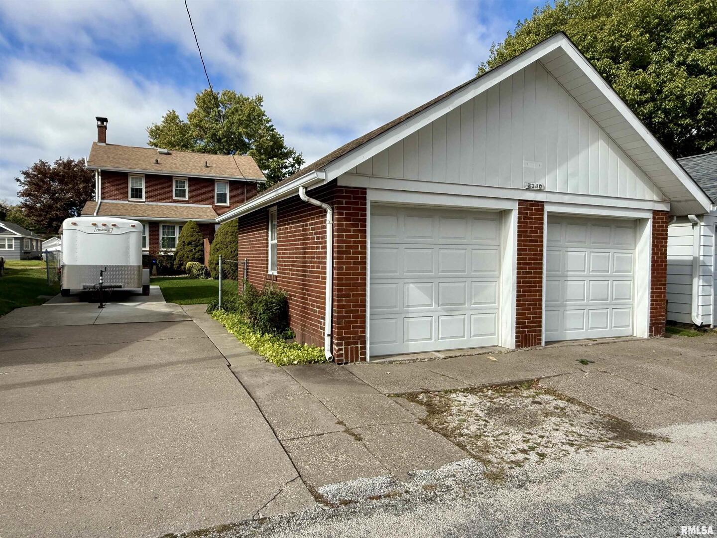 2340 7th Street East Moline, IL 61244 - Photo 24 of 26 a front view of a house with a yard and garage