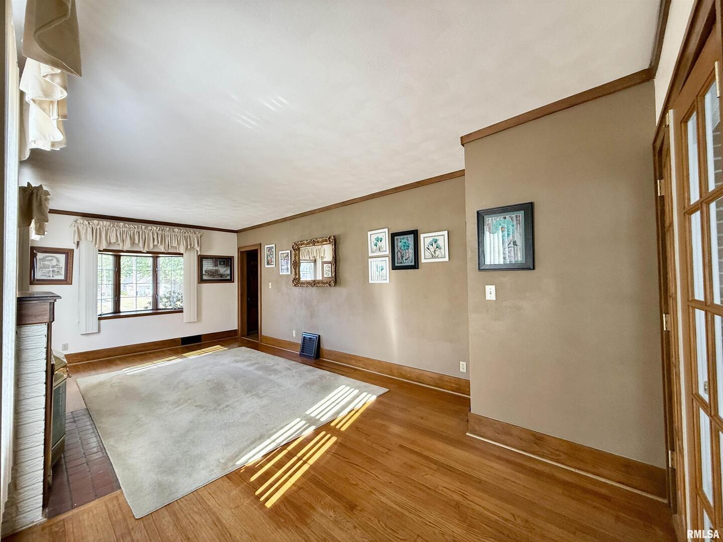 2340 7th Street East Moline, IL 61244 - Photo 3 of 26 a bedroom with a bed and a window