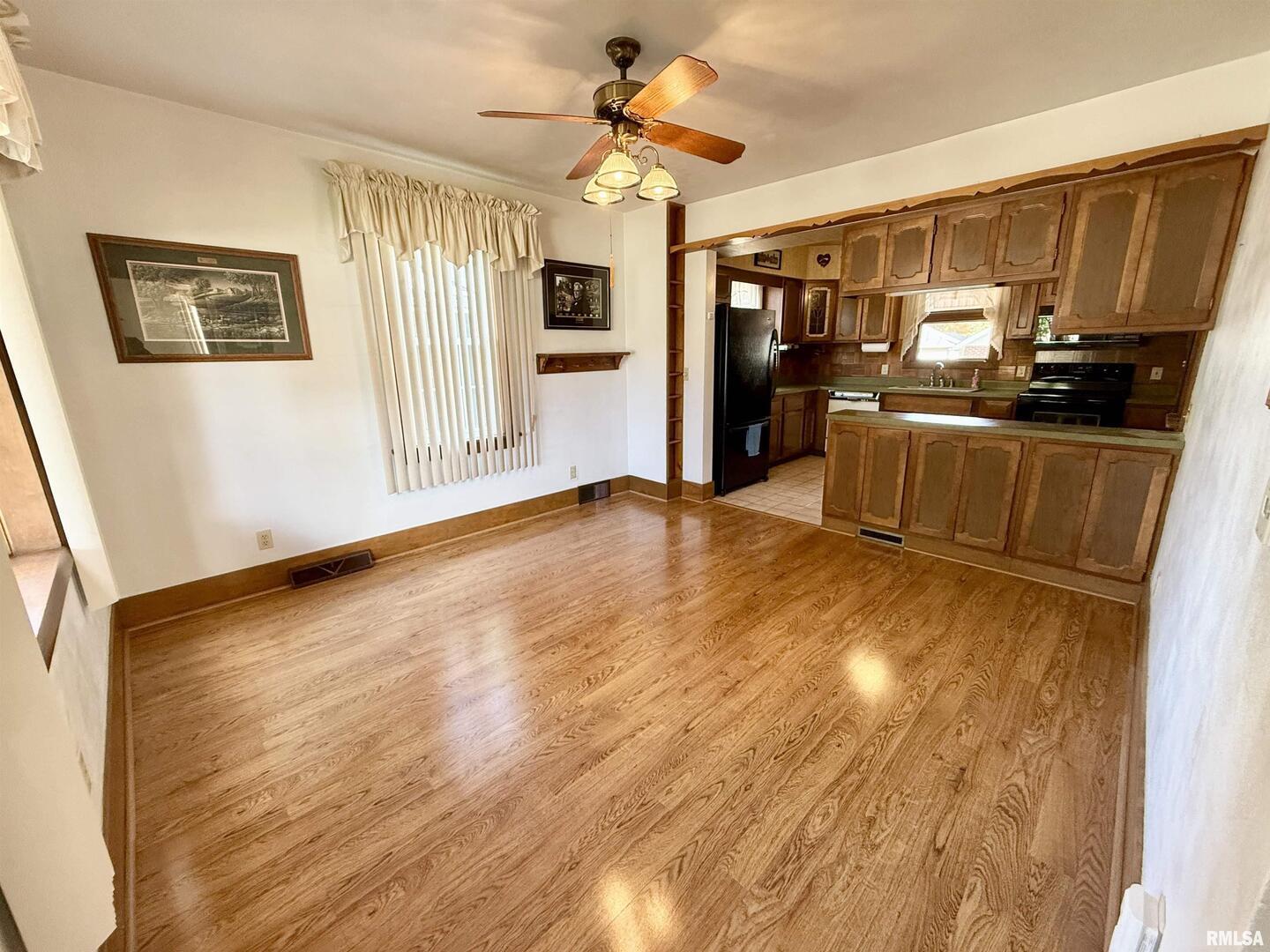 2340 7th Street East Moline, IL 61244 - Photo 5 of 26 a view of a kitchen with stainless steel appliances wooden floor and a refrigerator