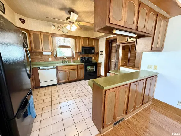 a kitchen with stainless steel appliances granite countertop a stove refrigerator and cabinets