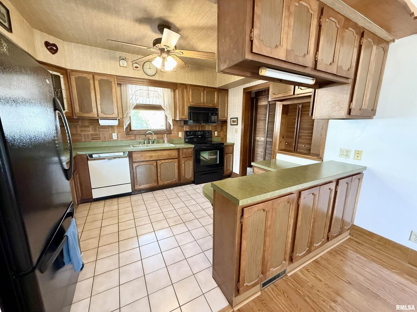 2340 7th Street East Moline, IL 61244 - Photo 6 of 26 a kitchen with stainless steel appliances granite countertop a stove refrigerator and cabinets