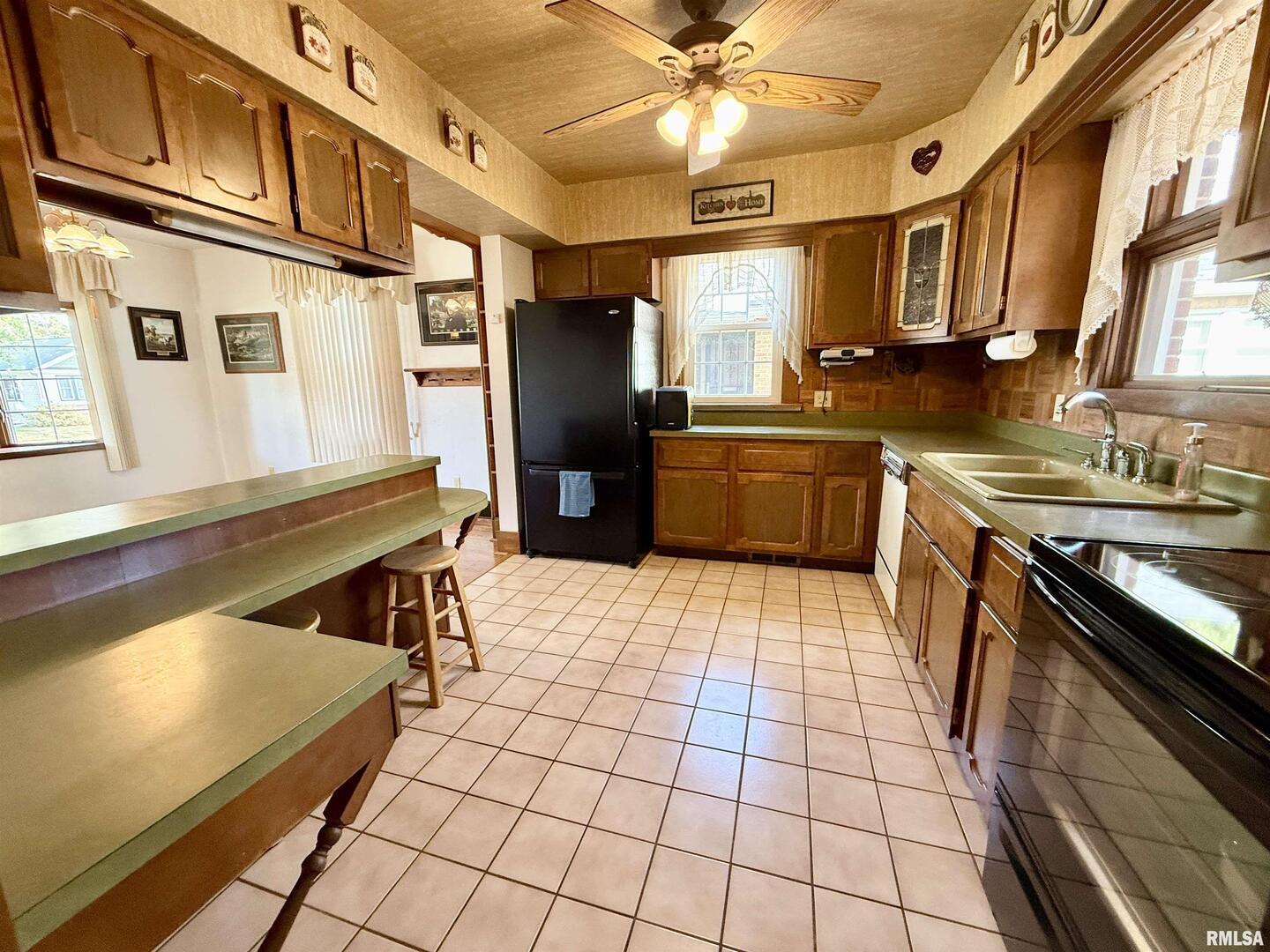 2340 7th Street East Moline, IL 61244 - Photo 7 of 26 a kitchen with stainless steel appliances granite countertop a refrigerator and a stove top oven