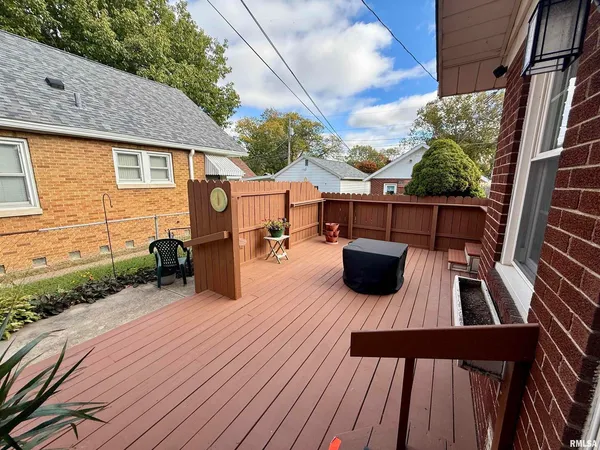 a view of a patio with table and chairs potted plants with wooden floor
