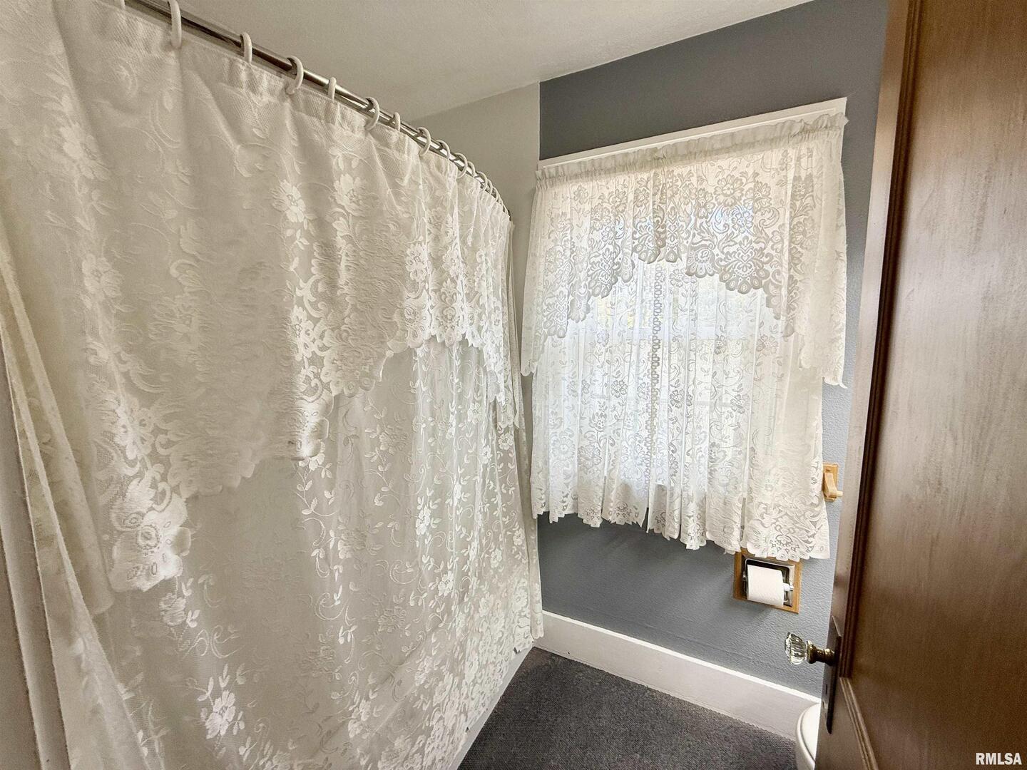 2340 7th Street East Moline, IL 61244 - Photo 9 of 26 a view of a bathroom with tub and shower curtain