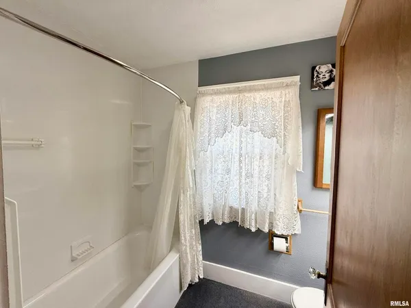 a bathroom with a tub and a shower
