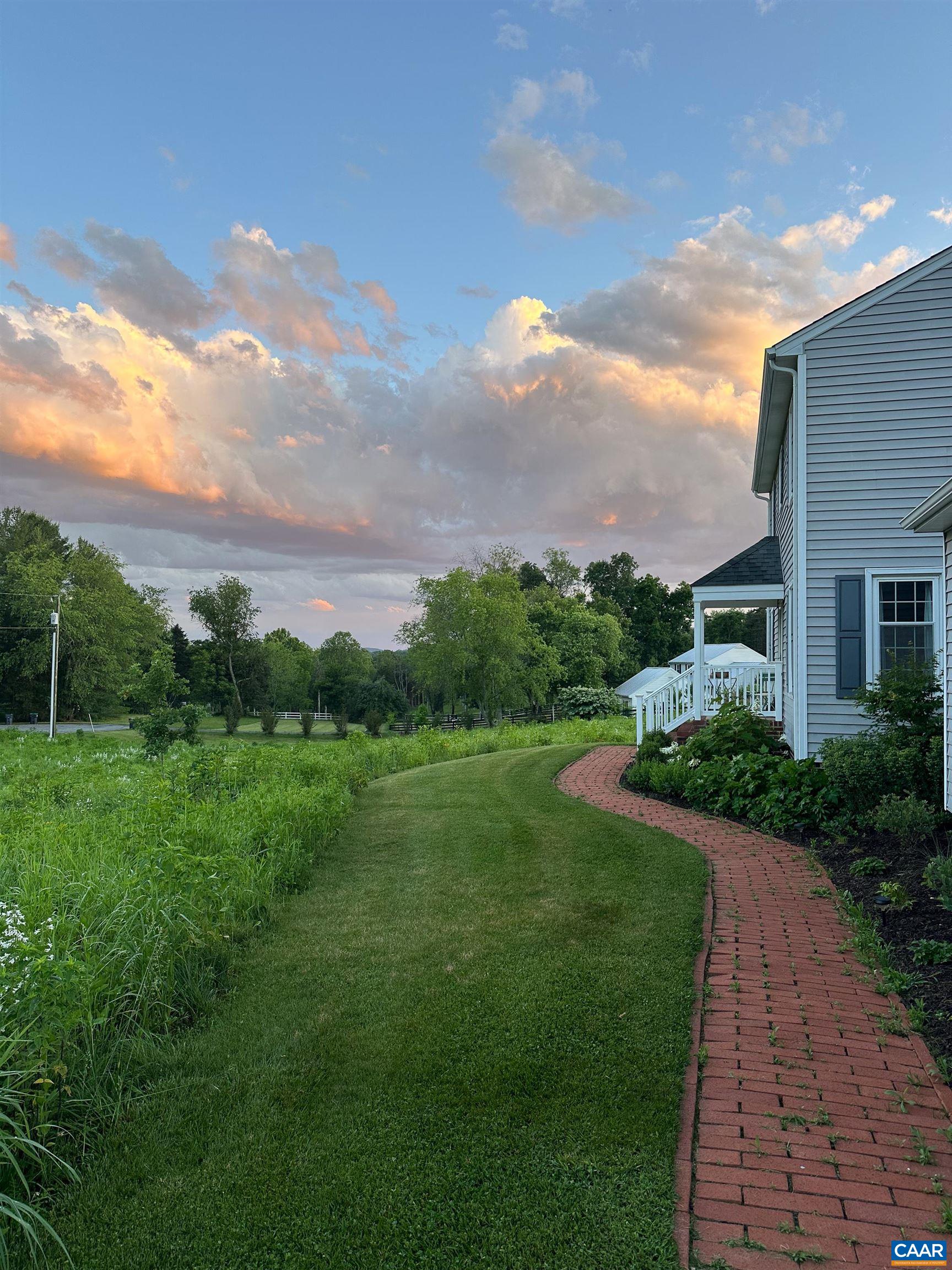 2706 Dunromin Road Charlottesville, VA 22901 - Photo 54 of 61 a view of a garden with a building in the background