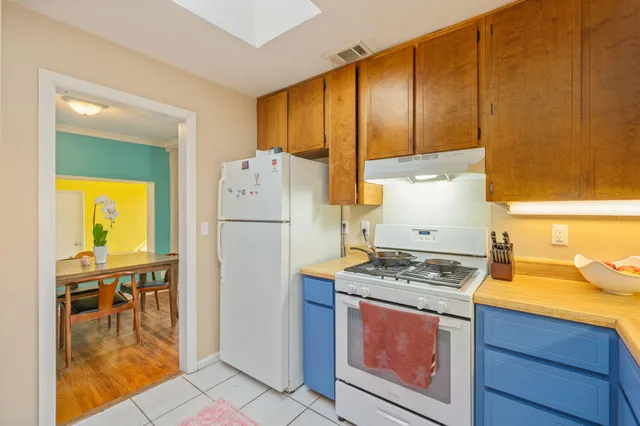 a kitchen with a refrigerator and a stove