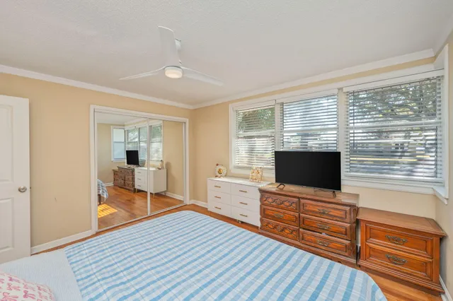 a view of a livingroom with wooden floor and furniture