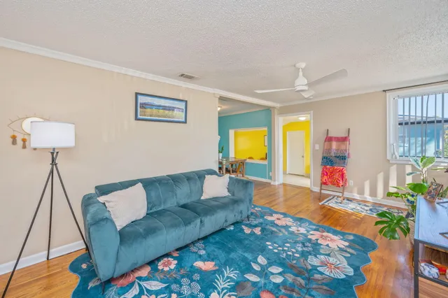 a living room with furniture and a wooden floor