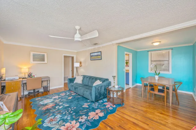 a living room with furniture and wooden floor