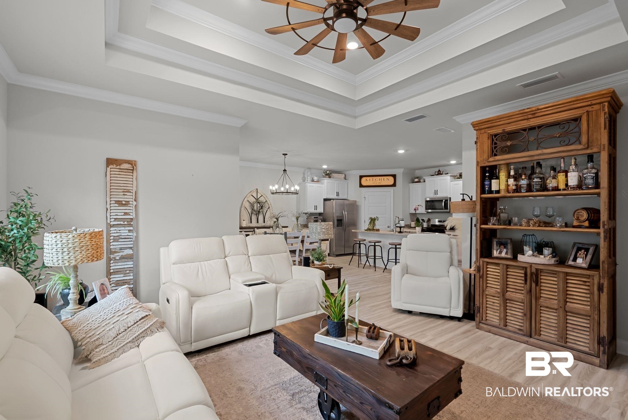 13966 Antler Hl Road Daphne, AL 36527 - Photo 12 of 44 Spacious living area featuring a tray ceiling with a ceiling fan, light wood-finish flooring, and an open concept layout