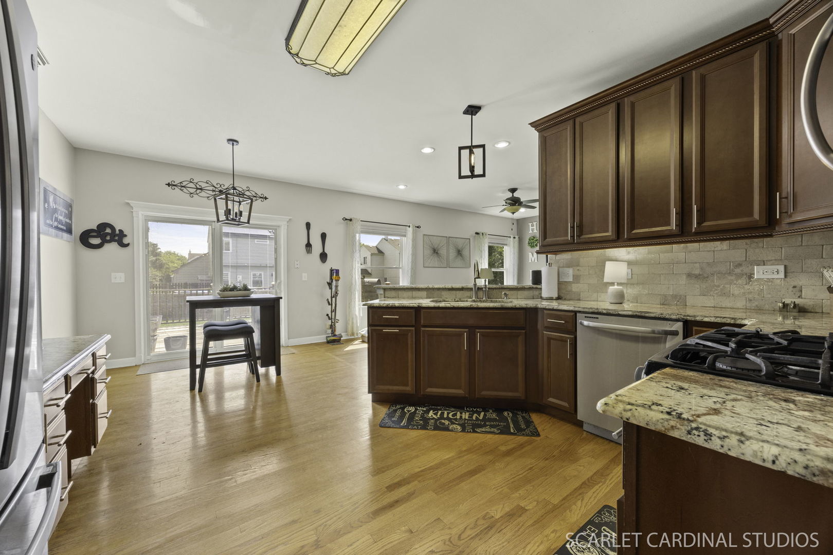 227 Faircroft Road Bartlett, IL 60103 - Photo 2 of 22 a kitchen with stainless steel appliances granite countertop wooden cabinets a stove top oven a sink and dishwasher