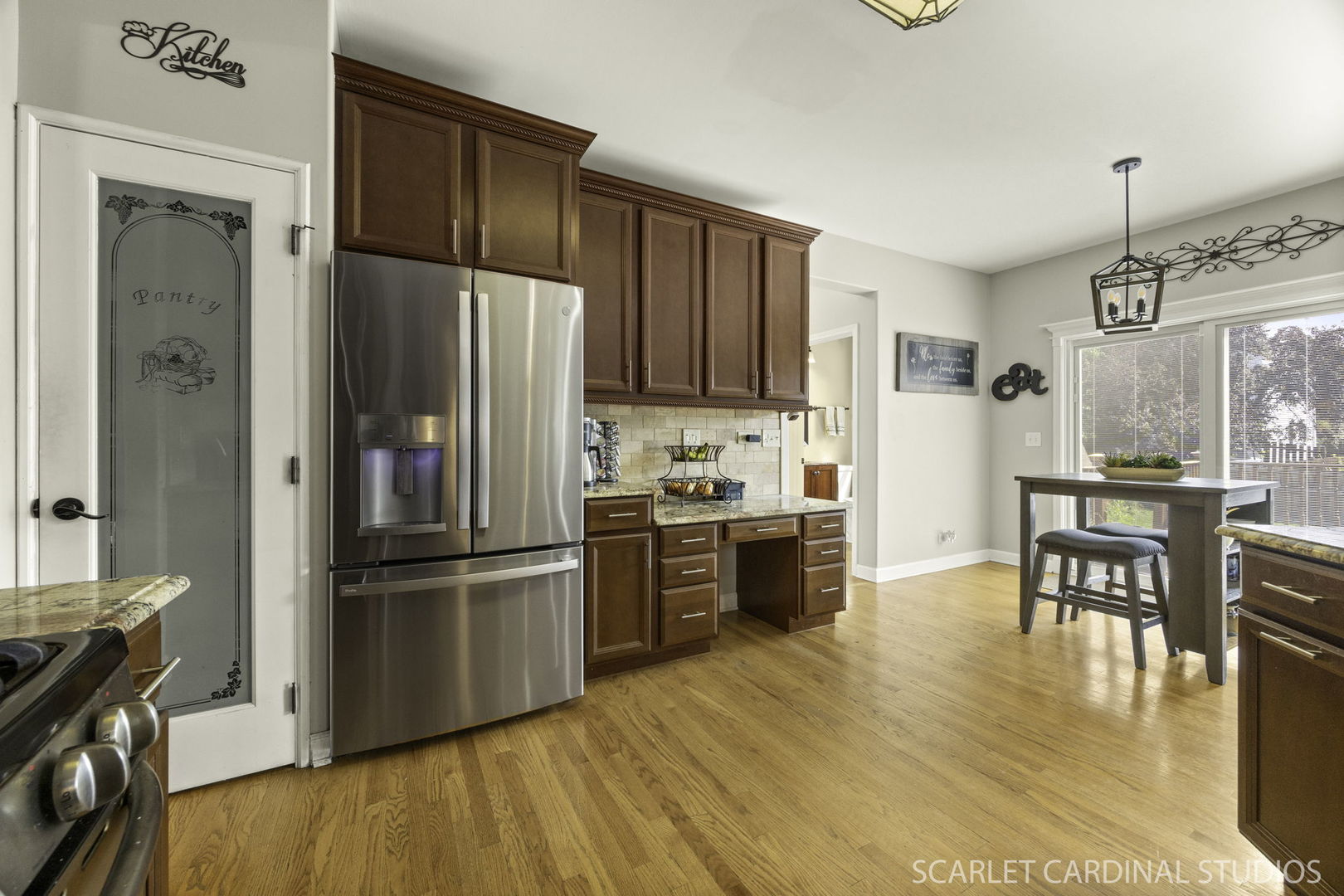 227 Faircroft Road Bartlett, IL 60103 - Photo 3 of 22 a kitchen with granite countertop wooden floors and stainless steel appliances