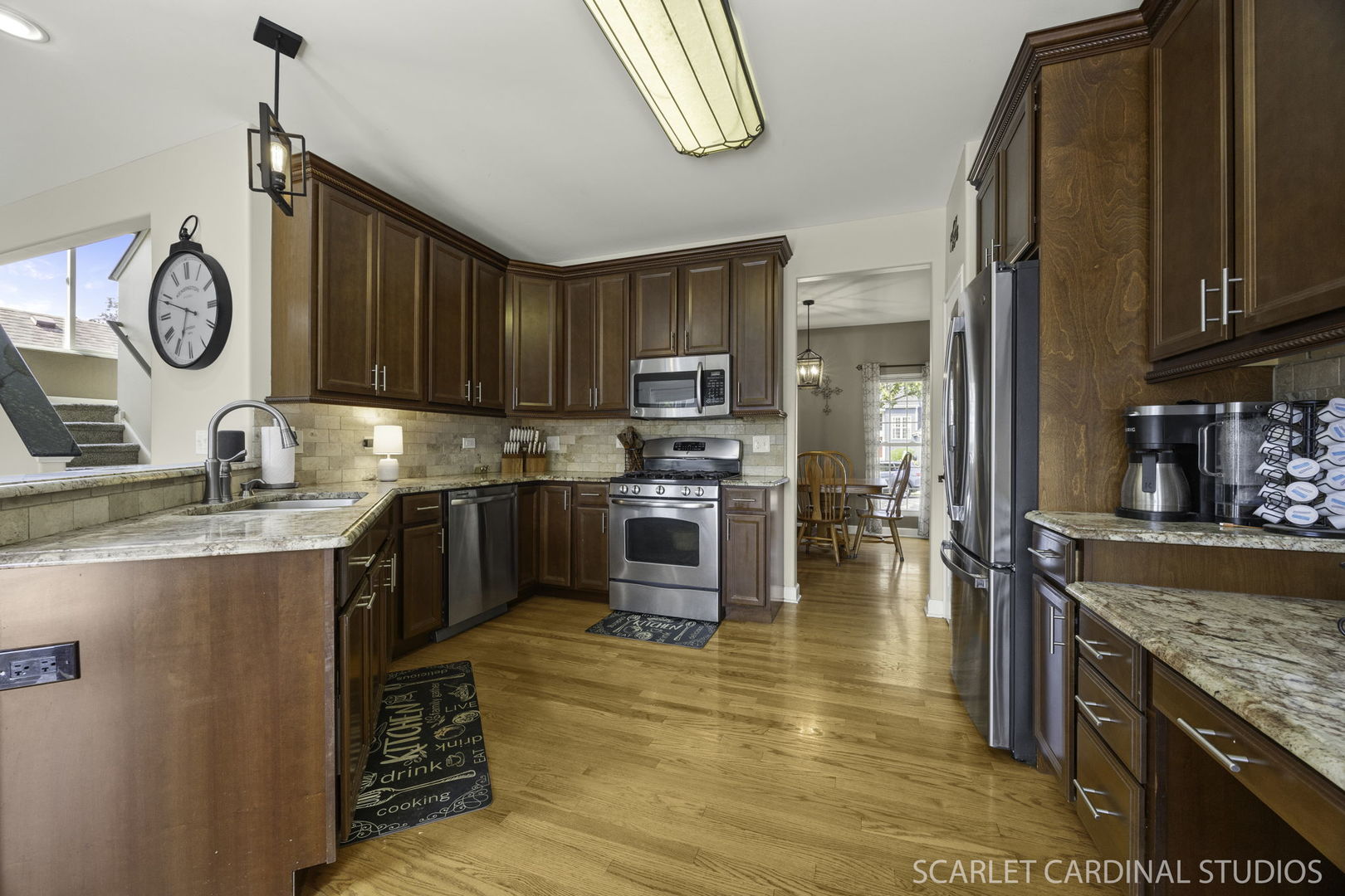 227 Faircroft Road Bartlett, IL 60103 - Photo 4 of 22 a kitchen with granite countertop a stove a sink and a refrigerator