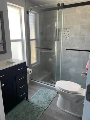 a bathroom with a toilet and a shower