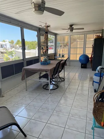 a living room with furniture a flat screen tv and a window