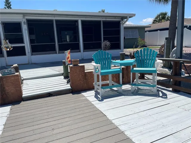a view of a deck with table and chairs