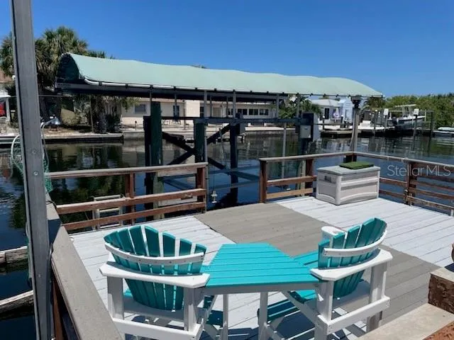 a roof deck with table and chairs