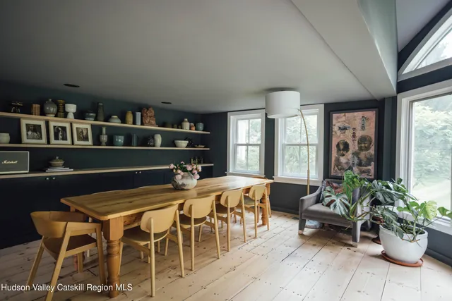 a living room with furniture a lamp and a potted plant