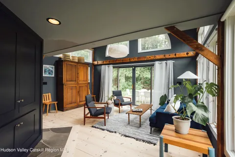 a living room with furniture and floor to ceiling windows