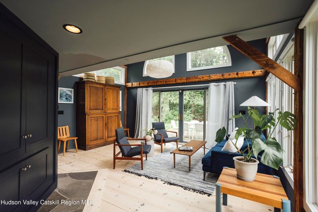 a living room with furniture and floor to ceiling windows