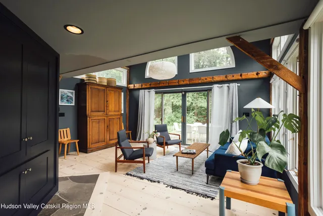 a living room with furniture and floor to ceiling windows