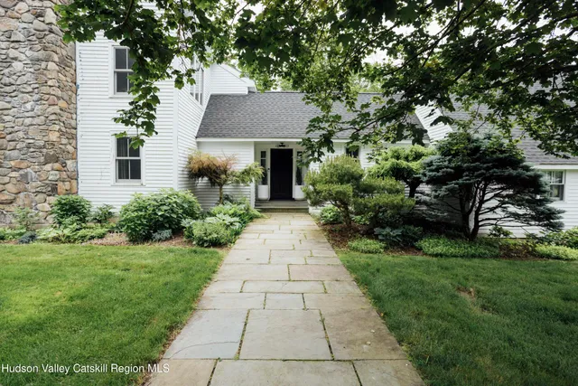 a front view of a house with garden