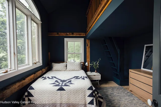 a bedroom with a bed and window