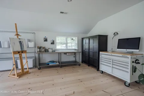 a view of a workspace with furniture and a window