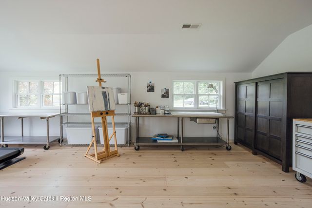 a view of a livingroom with furniture and a window