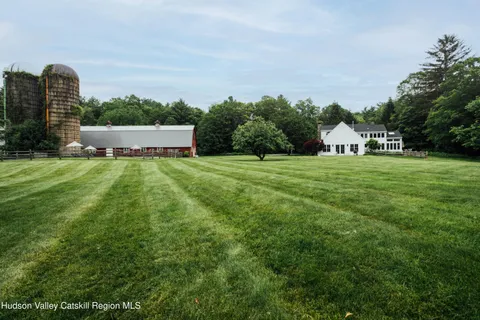 a backyard of a house with yard fountain and outdoor seating