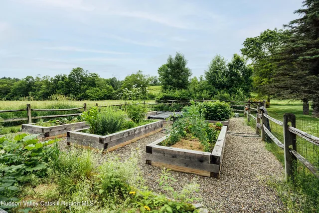 an aerial view of residential house with outdoor space and trees all around