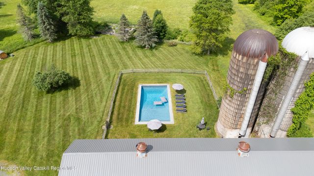 an aerial view of a house with a yard