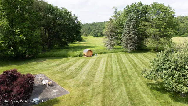 a front view of a house with a garden and trees