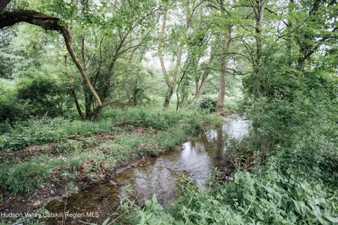 a front view of a house with a yard table and chairs