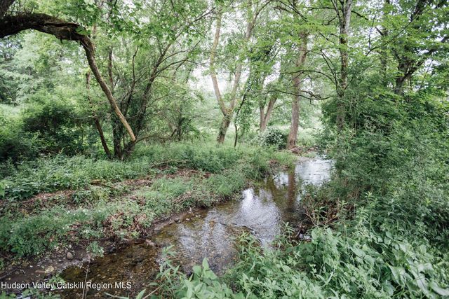 a front view of a house with a yard table and chairs