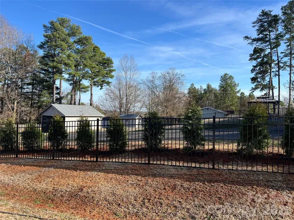 a view of a backyard with large trees