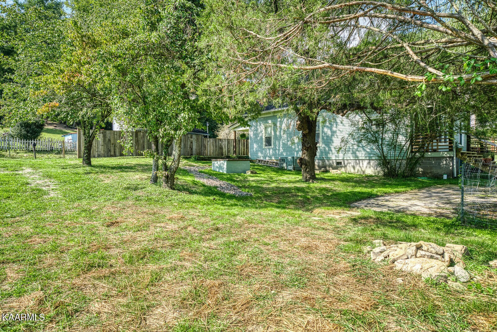 115 Spring Street Lancing, TN 37770 - Photo 7 of 33 a backyard of a house with lots of green space and fountain