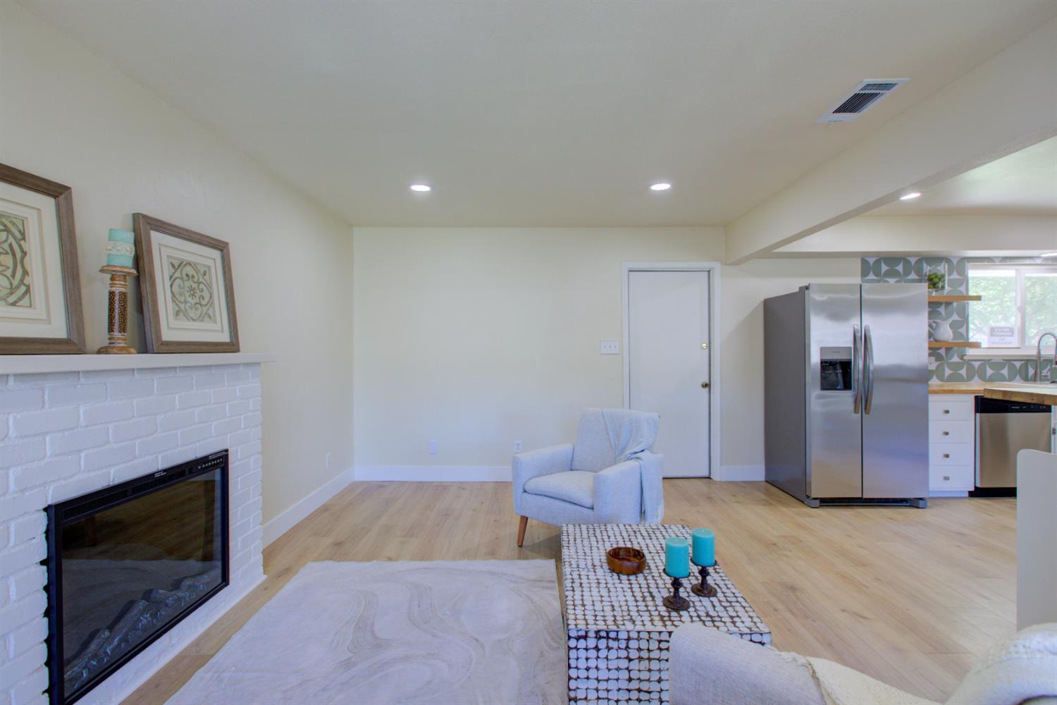 1673 Sacramento Drive Merced, CA 95348 - Photo 13 of 35 a living room with furniture and a fireplace