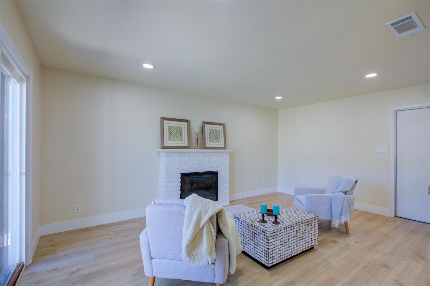 1673 Sacramento Drive Merced, CA 95348 - Photo 14 of 35 a living room with furniture and a fireplace
