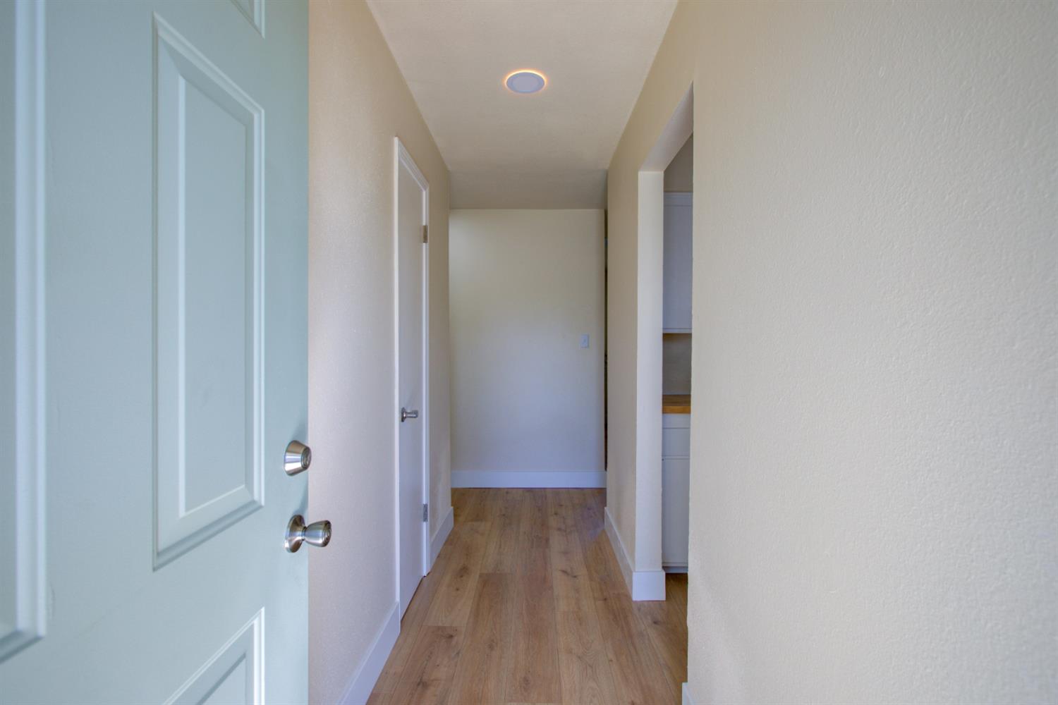 1673 Sacramento Drive Merced, CA 95348 - Photo 2 of 35 a view of a hallway with wooden floor