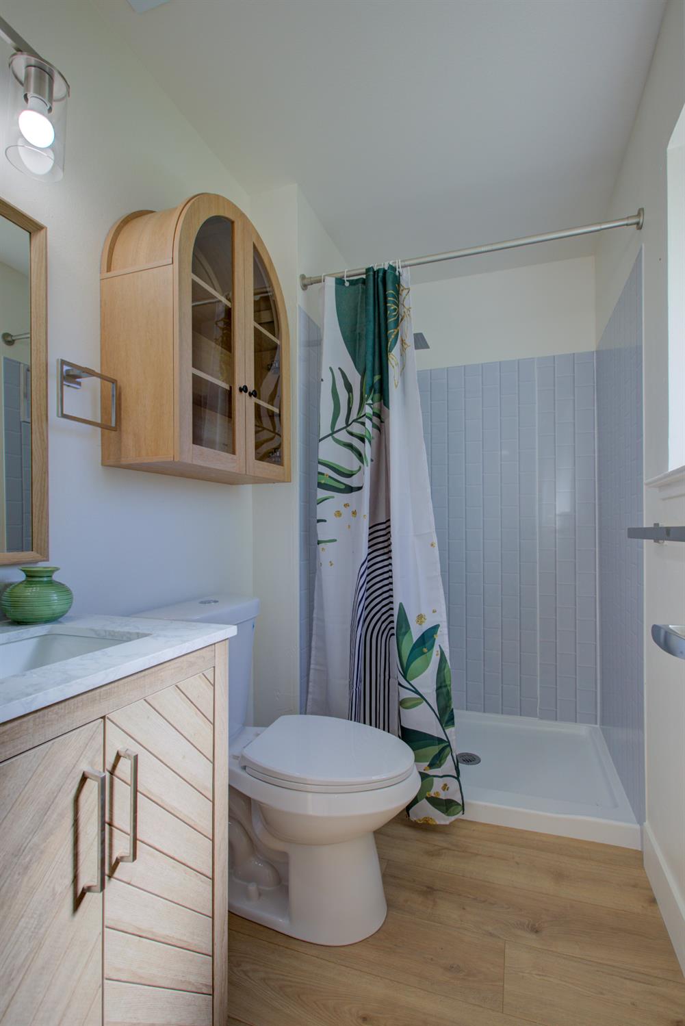 1673 Sacramento Drive Merced, CA 95348 - Photo 22 of 35 a bathroom with a sink a toilet and a shower
