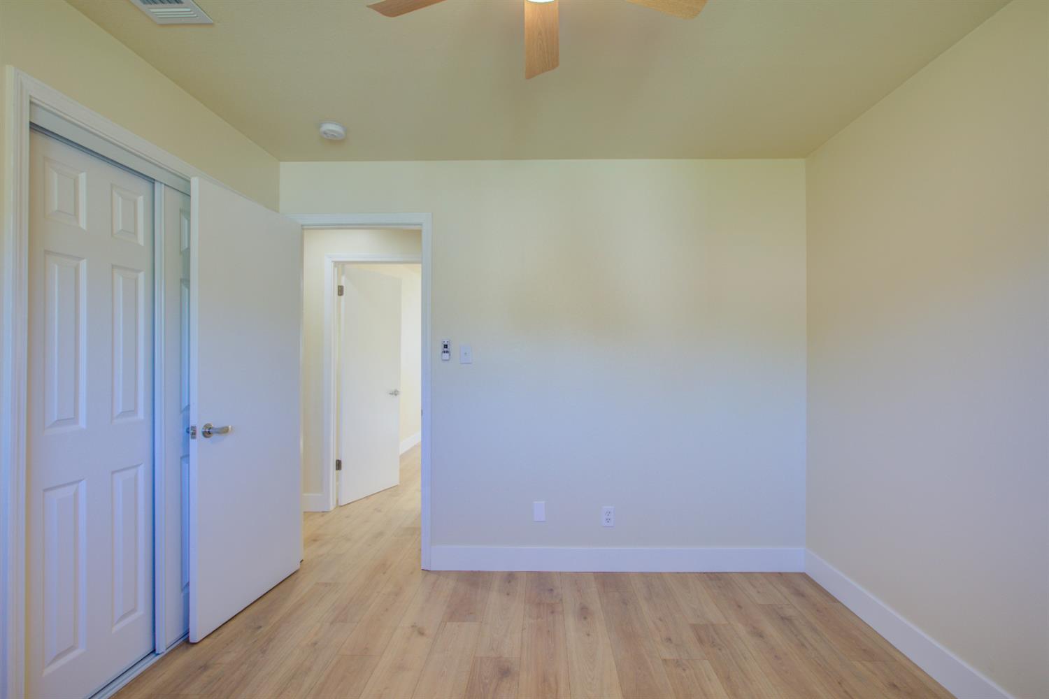 1673 Sacramento Drive Merced, CA 95348 - Photo 24 of 35 a view of a room with wooden floor