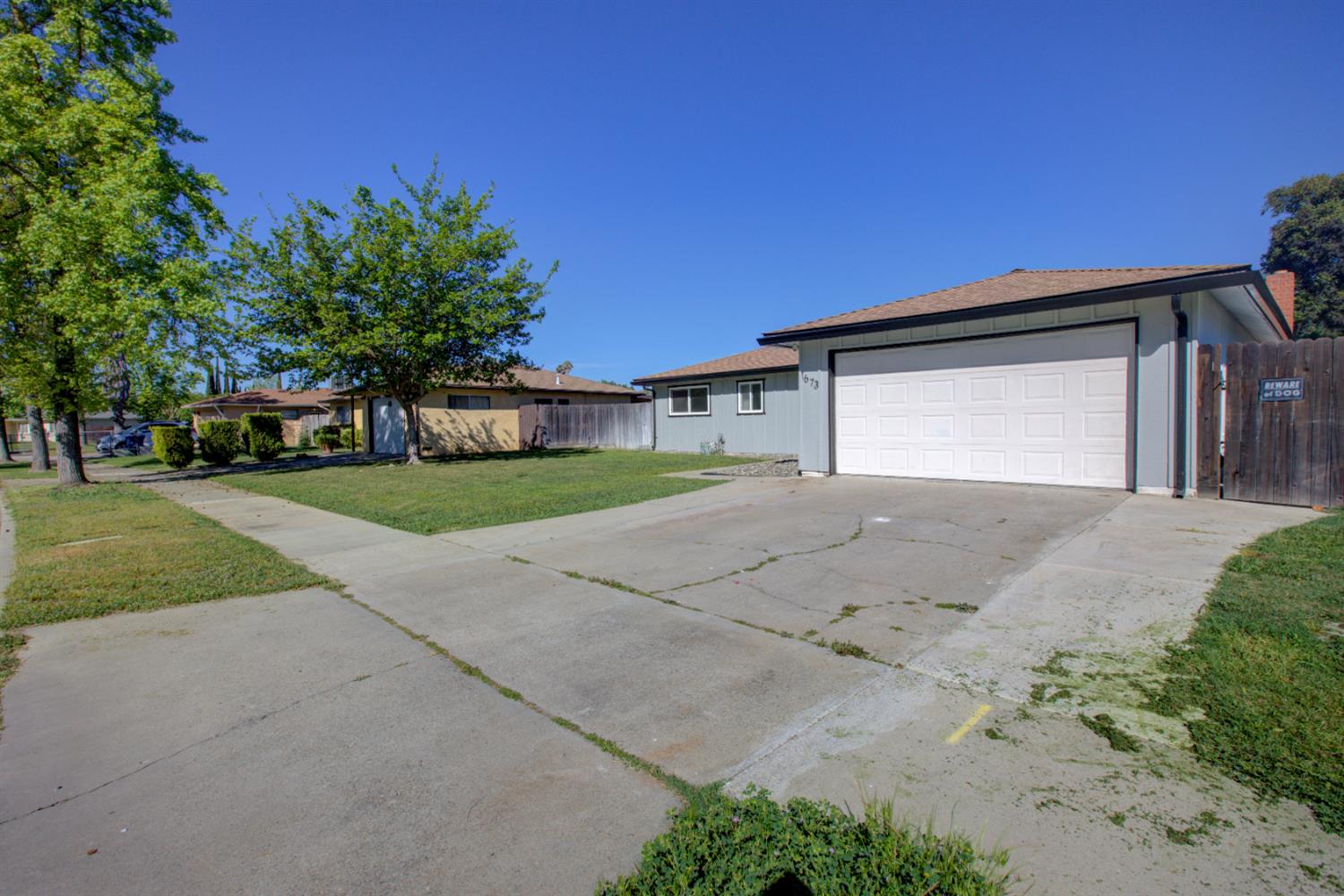 1673 Sacramento Drive Merced, CA 95348 - Photo 34 of 35 front view of a house with a street