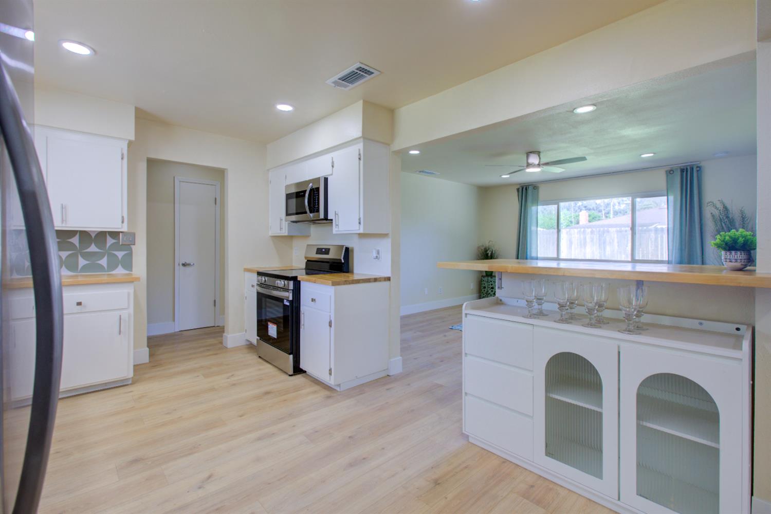 1673 Sacramento Drive Merced, CA 95348 - Photo 4 of 35 a kitchen with granite countertop a stove and a refrigerator
